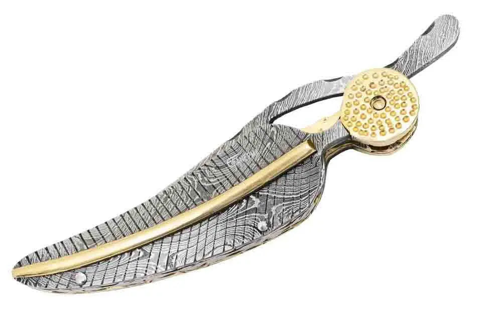 Faneema Cutlery artisan Damascus knife for collection with detailed metal feather design and gold accents