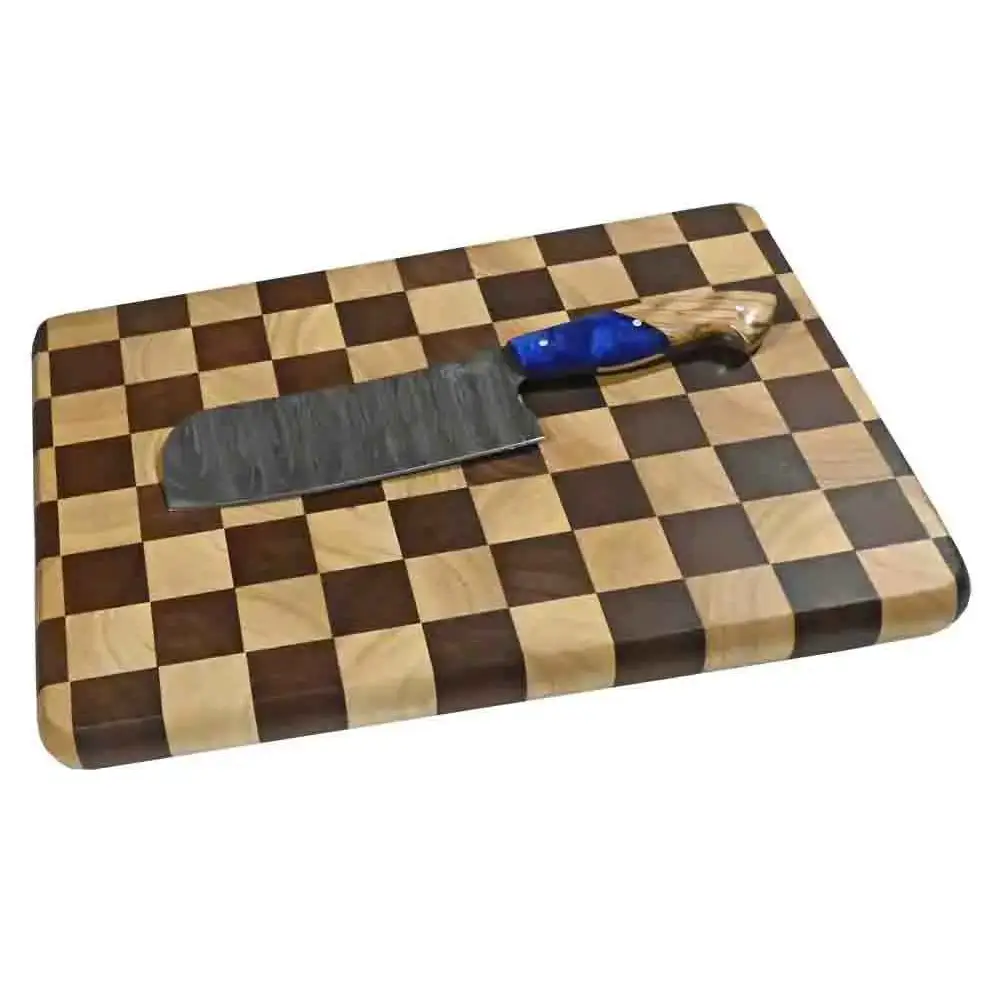 Sleek damascus steel cleaver with blue handle on lena checker cutting board