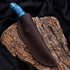 Blue marbled turquoise outdoor knife with leather sheath on tree bark