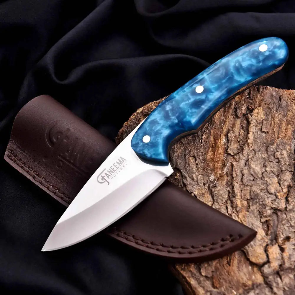 Sleek turquoise outdoor knife with marbled handle and Fanema steel blade