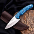 Sleek turquoise outdoor knife with marbled handle and Fanema steel blade
