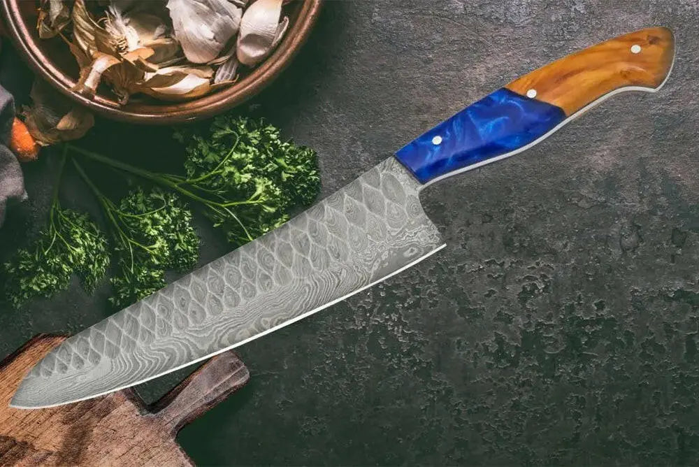 Faneema Cutlery Damascus chef knife premium with patterned blade and blue wooden handle on dark surface