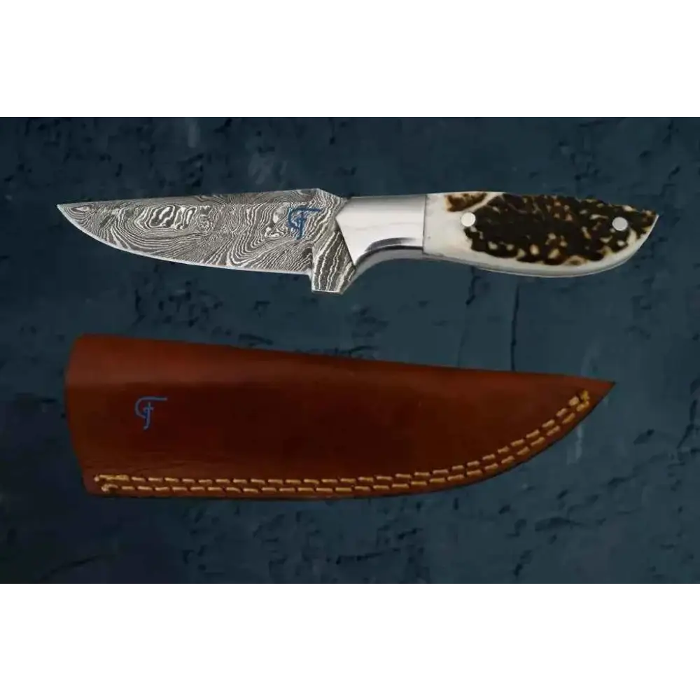 Damascus outdoor knife with antler handle and wavy silver blade