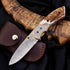 Damascus steel antler folding knife with gold accents