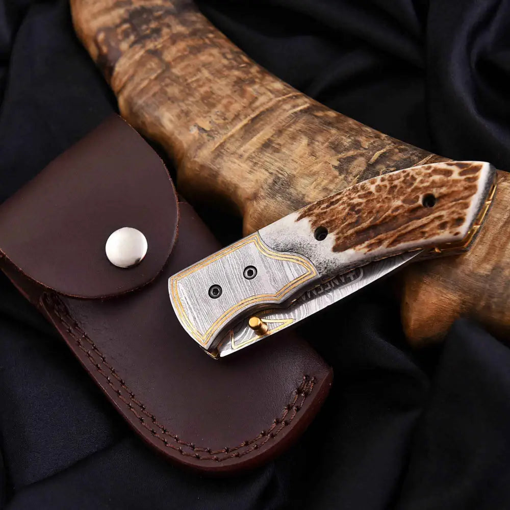 Damascus steel antler folding knife in leather sheath
