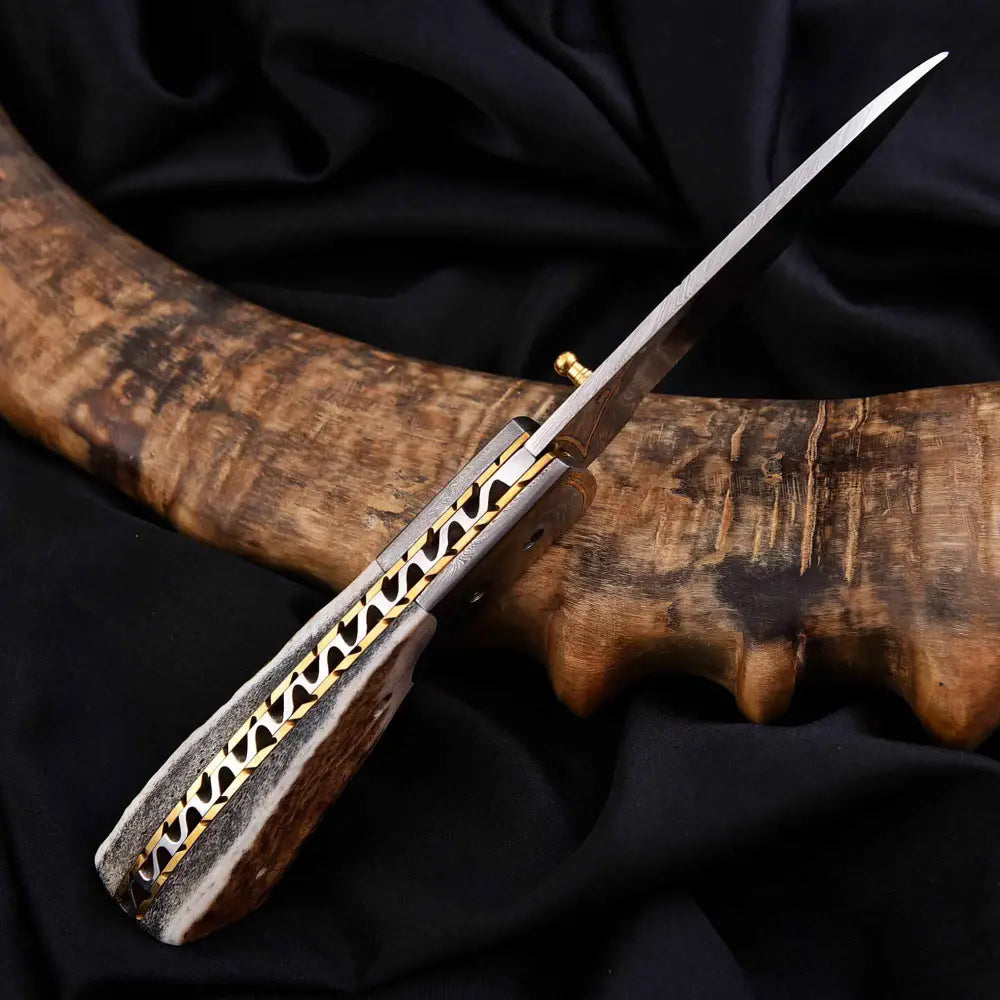 Damascus steel antler folding knife with polished silver blade