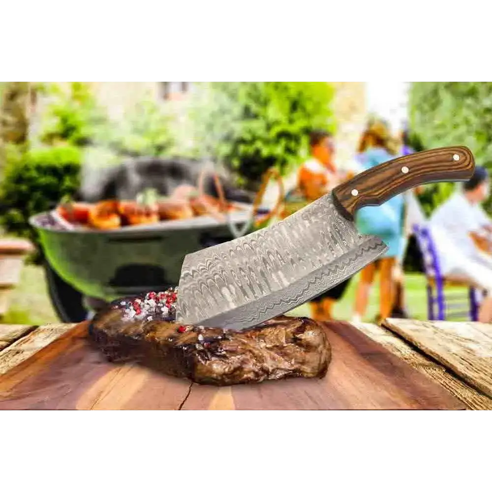 Faneema Damascus cleaver with wooden handle on seared steak