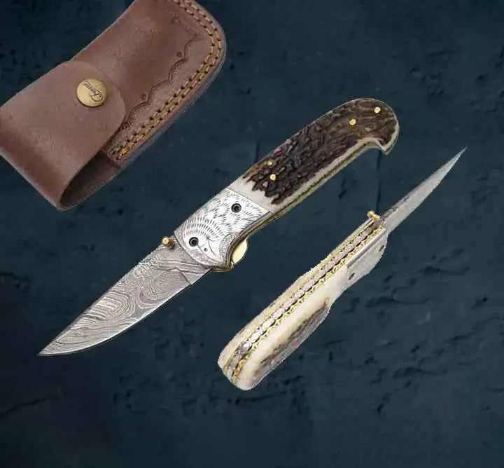 Damascus pocket knife with stag handle and engraved silver inlay