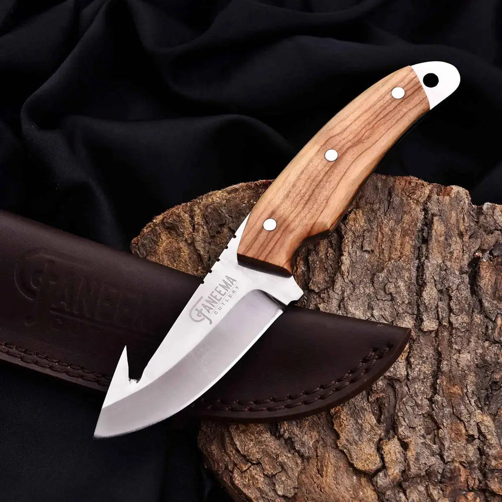 Silver blade gut hook knife with wood handle and leather sheath