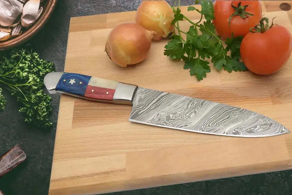 Faneema Cutlery Texas Damascus steel knife chef knife with Texas flag handle on wooden cutting board